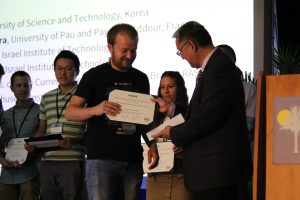 Sasha Rososhek receives the award diploma of the conference